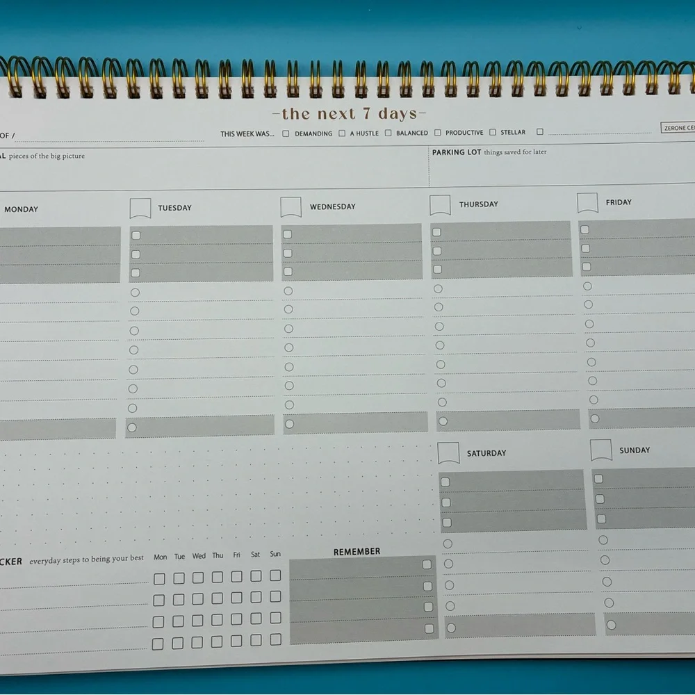 Zerone Productivity weekly planner featuring a gold spiral binding.